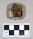 Copper alloy with iron, buckle with ferrous pin spanning interior, pin is heavily corroded