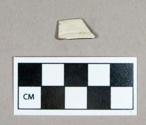 Ceramic, white salt glazed stoneware rim sherd, incised lines on both sides