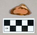 Ceramic, glazed redware body sherd with slip decoration on exterior