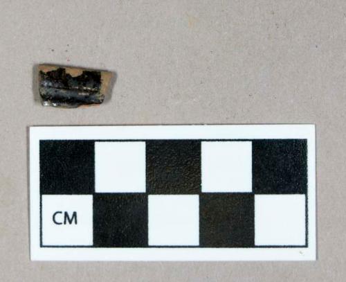 Ceramic, dark brown lead glazed redware rim sherd