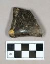 Glass, olive green bottle base/heel fragment