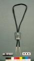 Cast silver bolo tie depicting mountains and a head