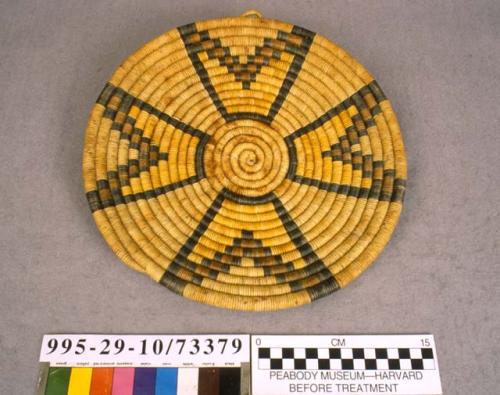 Coiled circular plaque with geometric motif