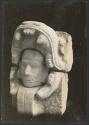 Northwest Colonnade, carved stone figure of human head in serpent's mouth