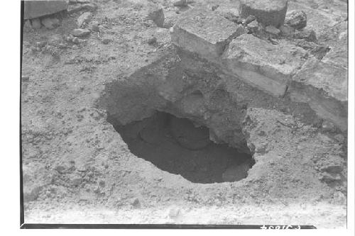 Caracol looking west. Olla under masonry block top of niche upper stairway.