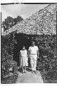 Vitaliano Herrera and his wife in front of house