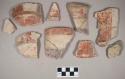 Ceramic, earthenware body, base, and rim sherds, with red, white, and purple slipped decoration, some with striped and swirled decoration, grit-tempered; some sherds crossmended with glue; some sherds crossmend