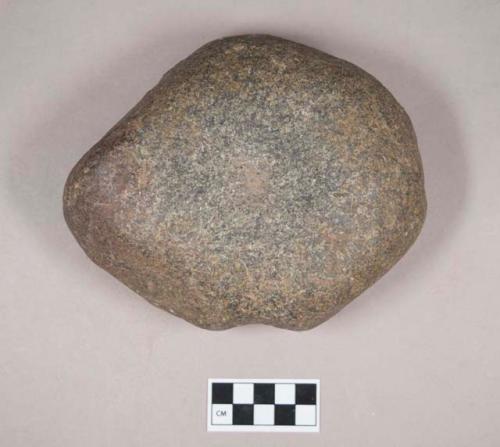 Ground stone, mortar, one side concave, one side has one pecked pit, pitted pounding stone