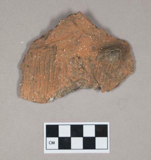 Ceramic, earthenware body sherd, incised and cord-impressed, shell-tempered, with handle fragment or lug