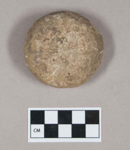 Ground stone, pecked discoidal stone, concave on both sides