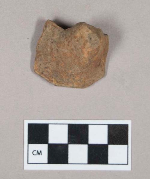 Ceramic, earthenware foot or handle sherd, undecorated, grit-tempered