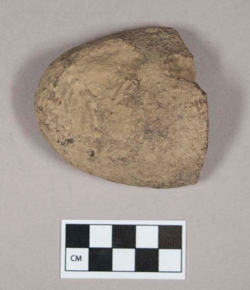 Ground stone, pecked and ground stone fragment, pitted on one side