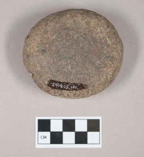Ground stone, pecked and ground round stone fragment