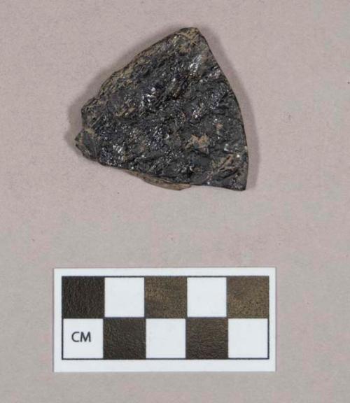 Organic, worked coal fragment, flat, one rounded edge