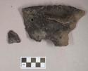 Ceramic, earthenware rim, handle, and body sherds, notched rim above handle, undecorated body, one sherd perforated, burned material on interior, shell-tempered; two sherds crossmend