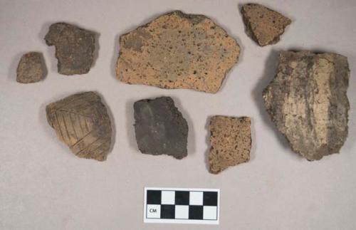 Ceramic, earthenware body sherds, some undecorated, one incised, grit-tempered; two sherds crossmend