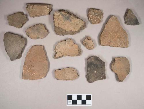 Ceramic, earthenware body, base, and rim sherds, some undecorated, some cord-impressed, grit-tempered; some sherds crossmend