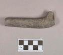 Ground stone, elbow pipe fragment, carved design
