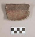 Ceramic, earthenware rim sherd, undecorated, red ochre on interior