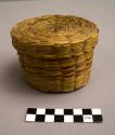 Covered sweetgrass basket with faded crimson-dyed splints