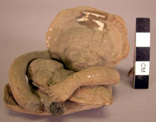 Ceramic figurine, moulded, incised seated human, holding infant