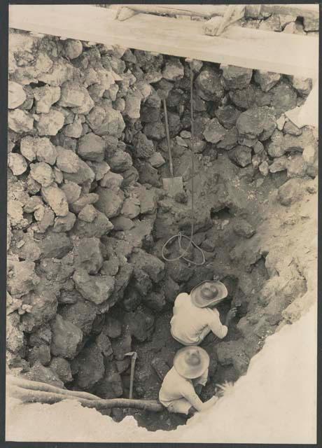 El Caracol, workers in trench at base of upper stairway