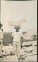 Caracol, worker carrying stone nose for south doorway mask panel