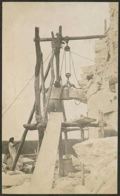 Caracol, raising stone block for restoration of five-member cornice