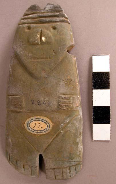 CAST, carved, incised, perforated human figure, green and black pigment