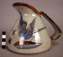 Ceramic pitcher with bird, butterfly + floral motif