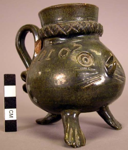 Dark green glazed handled pot with tripod