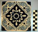 Tile, light and dark blues on white background in square pattern. red clay