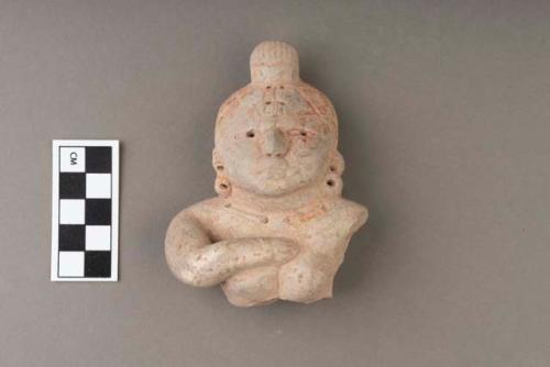 Archaic pottery figurine- woman's head with hand across breast