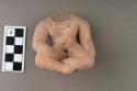 Archaic pottery figurine- headless figure seated with legs crossed