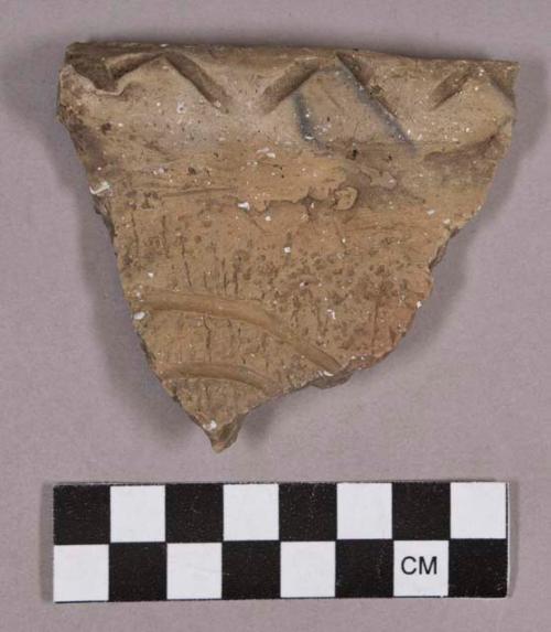 Ceramic, earthenware rim sherd, shell-tempered, curved incising on body, chevron-incised rim