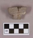 Ground stone, pipe bowl fragment, mended, rectangular-shaped bowl with incised lines around rim