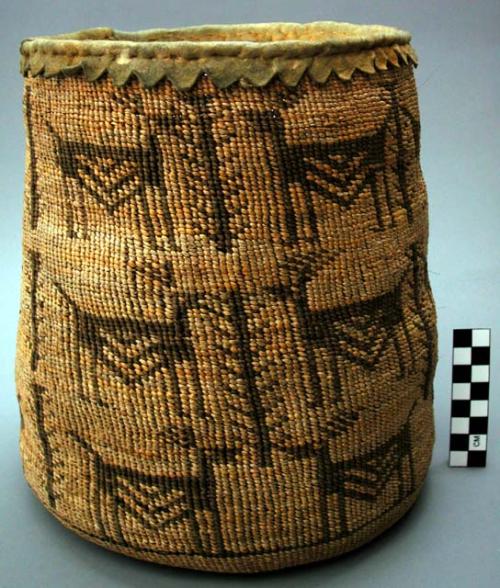 Basket--stylized animal decoration in brown; skin fringe around top