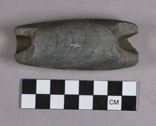 Ground stone, oval atlatl weight, tubular, fragmented