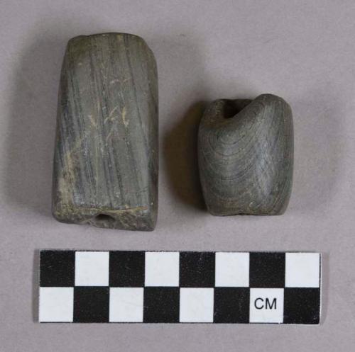 Ground stone, modified lithic tubes, one grooved