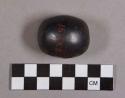 Ground stone, hematite object, oval-shaped with one flat side, burnished
