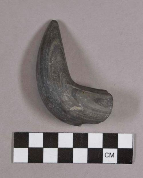 Ground stone, fragment, horn-shaped object, fragmented at perforation