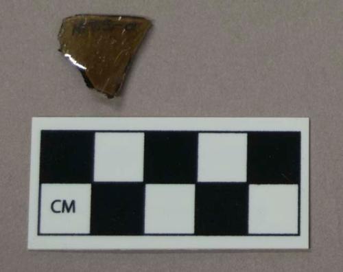 Glass, brownish green curved glass bottle fragment