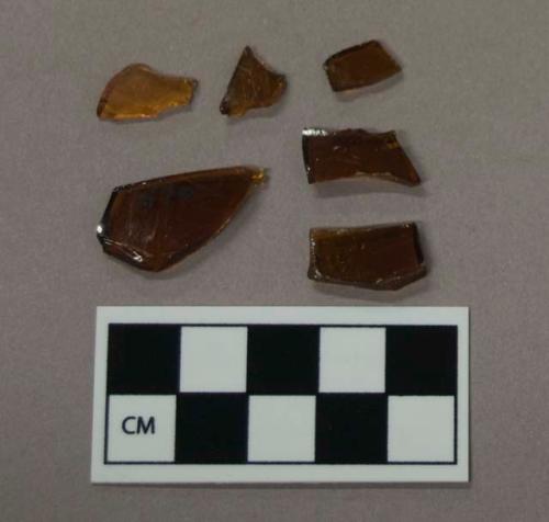 Glass, amber curved bottle body fragments