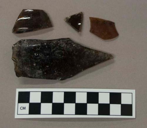 Glass, brown curved bottle body fragments