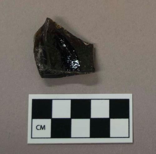 Glass, curved brown bottle body fragment