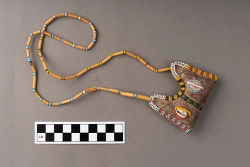 Necklace of plant segments and bead chain; leather pendant with two cowries, beaded decoration