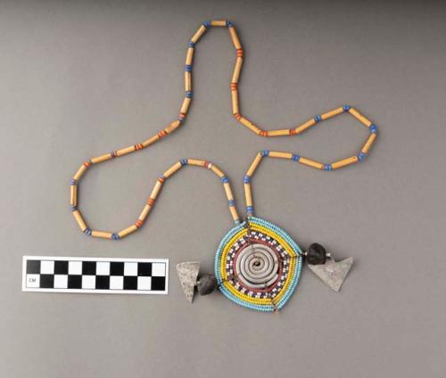 Necklace of plant segments separated by glass beads, multicolored pendant of coiled metal and beads with two metal triangles