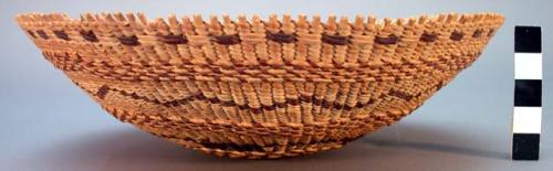 Circular flaring twined basket, natural with brown and light tan design.