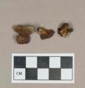 Metal, unidentified nail fragments attached to stones