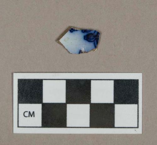 Ceramic, pearlware body sherd with flow blue decoration on interior